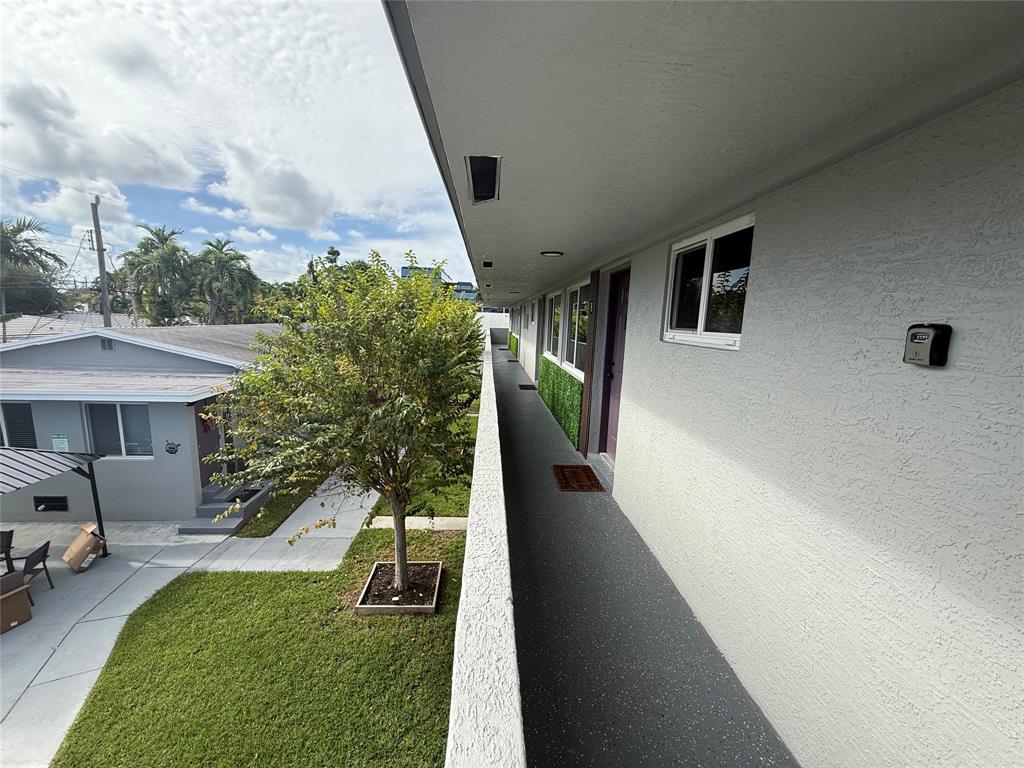 720 Northeast 7th Street, Unit 7 Hallandale Beach, FL 33009 - Photo 2 of 7 a house view with a garden space