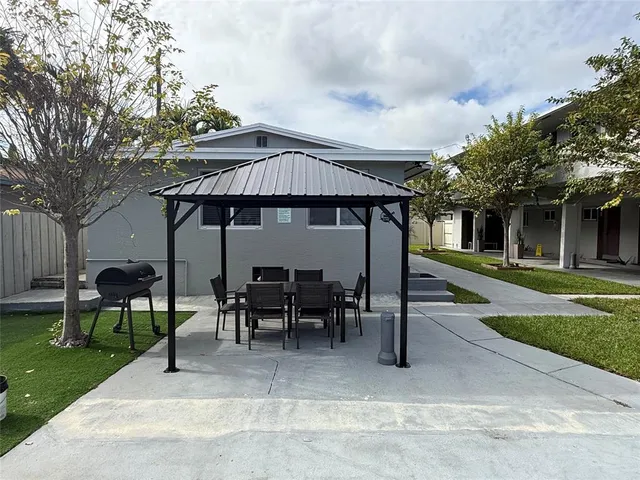 a view of a house with backyard porch and sitting area