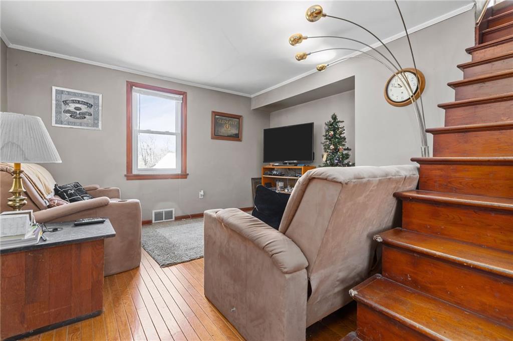 745 Park Quarry Road Freedom, PA 15042 - Photo 5 of 22 a living room with furniture a clock and a flat screen tv