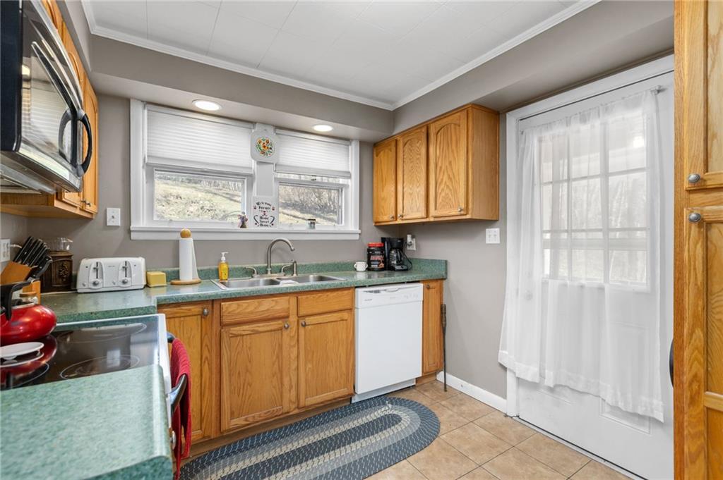 745 Park Quarry Road Freedom, PA 15042 - Photo 8 of 22 a kitchen with stainless steel appliances granite countertop a stove a sink and a refrigerator