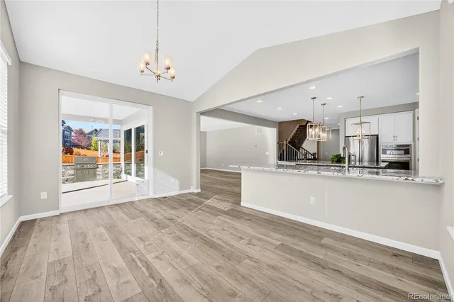 a view of a kitchen with a sink wooden floor and a kitchen counter top space
