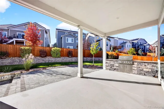 a view of a back yard of the house and front view of a house