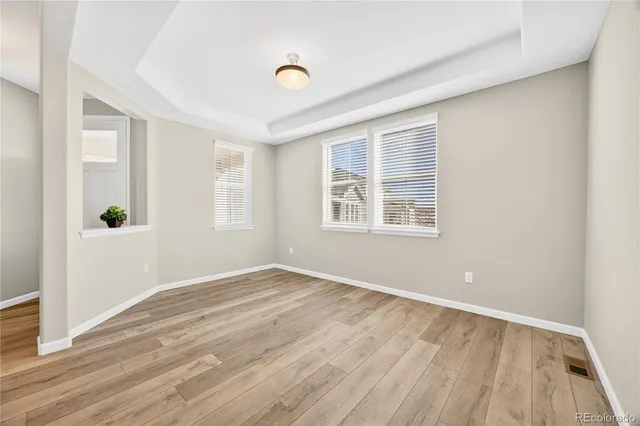 a view of a hallway with wooden floor and closet