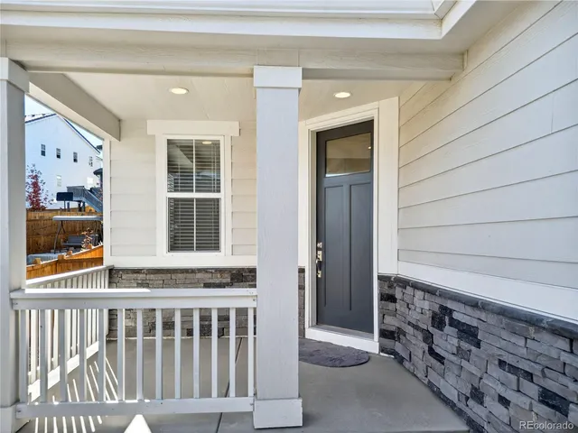 a front view of a house with a garden and plants