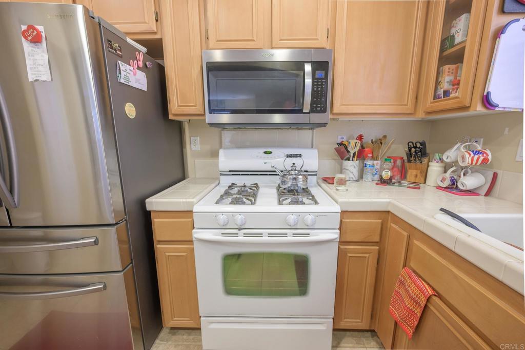 1451 Montage Escondido, CA 92029 - Photo 5 of 17 a kitchen with stainless steel appliances granite countertop a refrigerator stove and sink