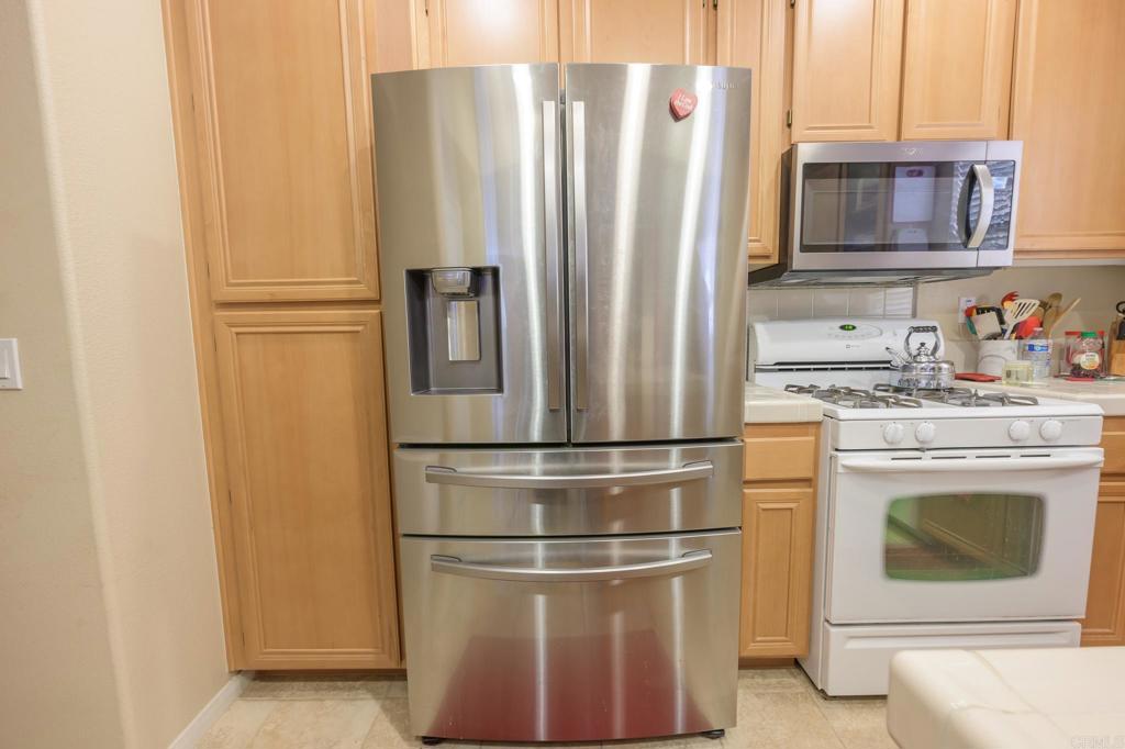 1451 Montage Escondido, CA 92029 - Photo 6 of 17 a kitchen with stainless steel appliances a refrigerator stove and microwave