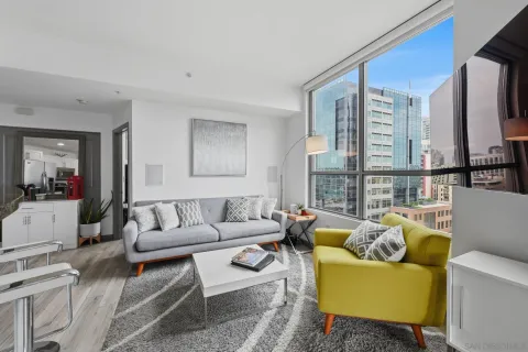 a living room with furniture a rug and a large window