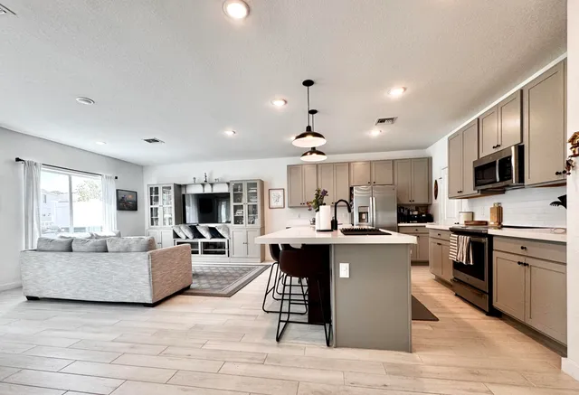 a kitchen with a sink stove and microwave