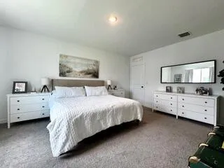 a bed room with furniture and a night stand