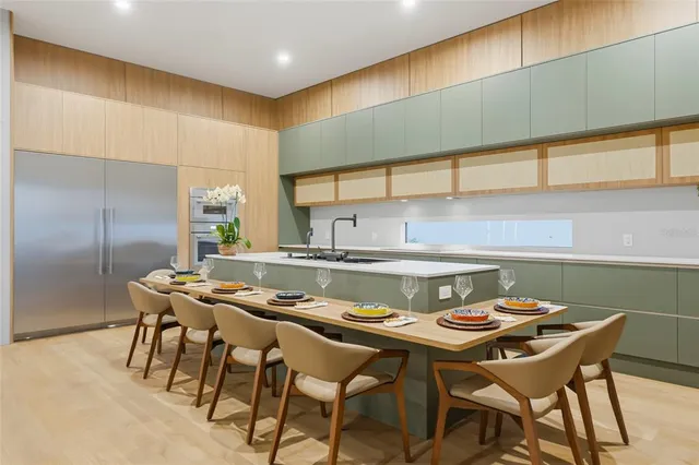 a kitchen with a table chairs and a stove