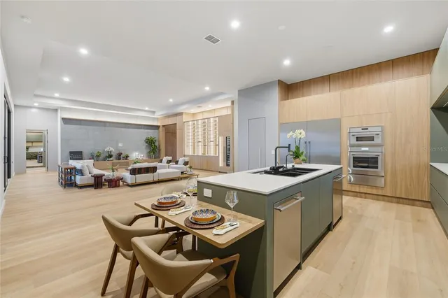 a kitchen with sink stove and chairs