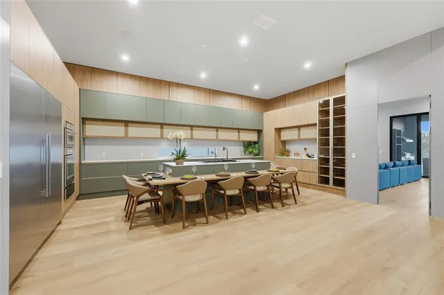 a large kitchen with a table and chairs