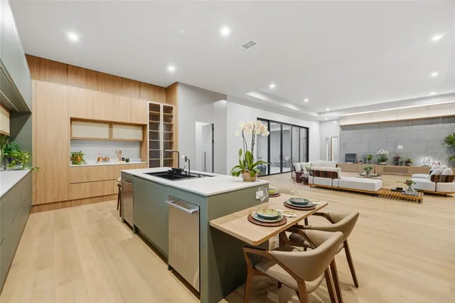 a kitchen with a sink a stove and chairs
