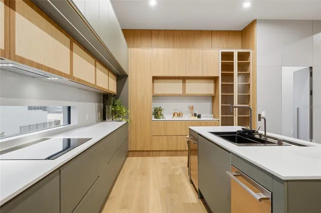 a kitchen with a sink and a stove top oven