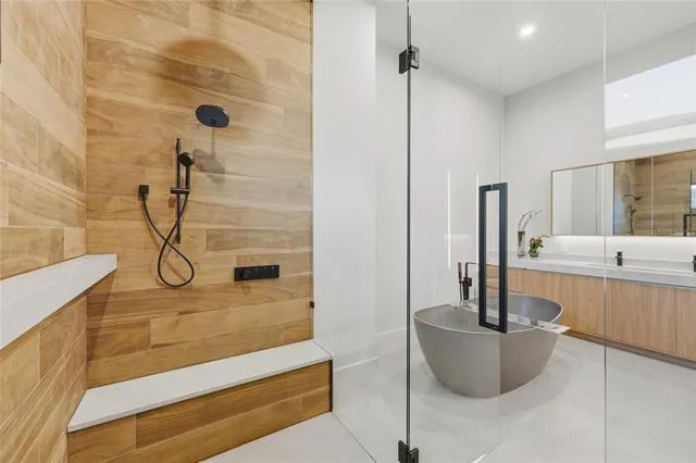 a bathroom with a granite countertop bathtub shower