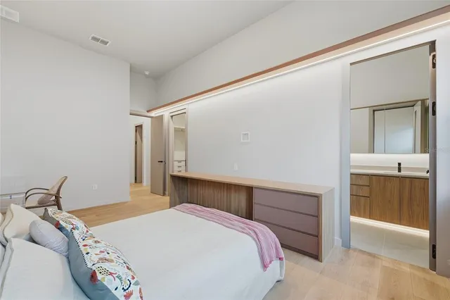 a bedroom with a bed and a dresser