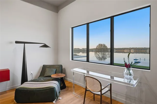 a living room with furniture and a floor to ceiling window