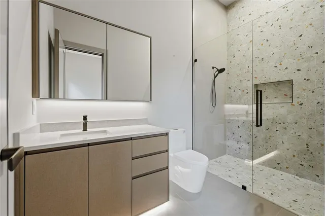 a bathroom with a sink toilet and shower