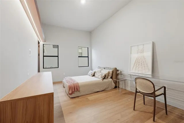 a bedroom with a bed and chair