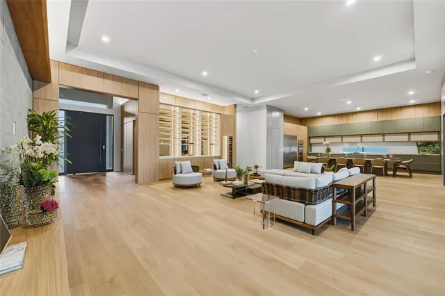 a living room with furniture and potted plants