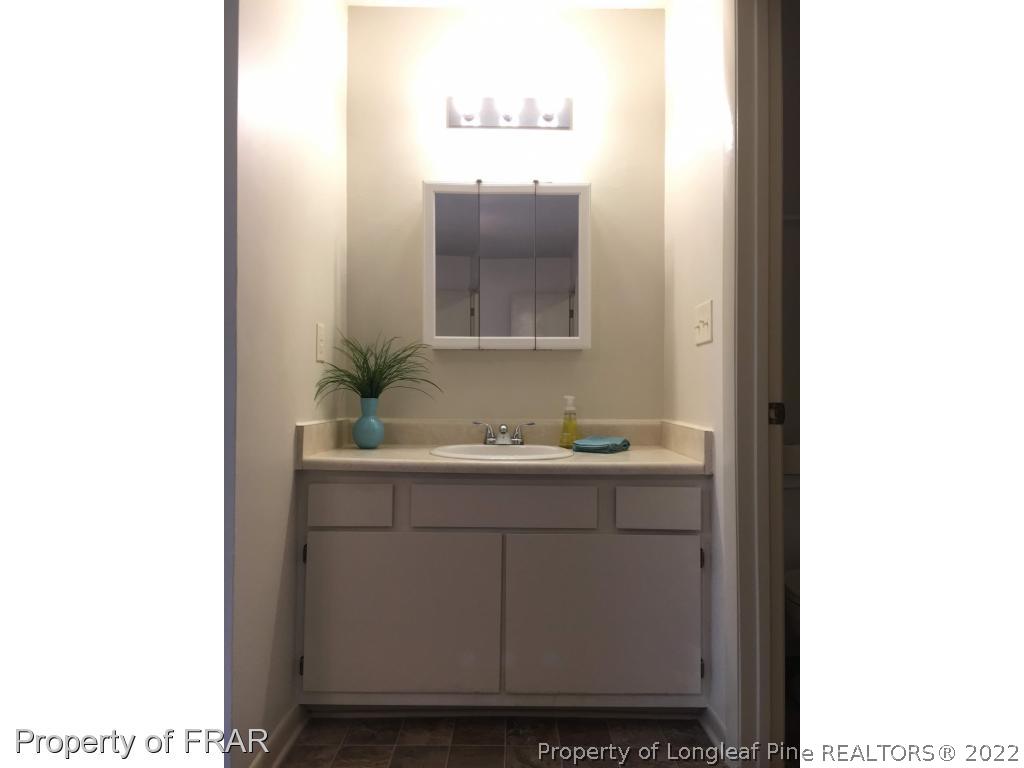 1733 Rim Road Fayetteville, NC 28314 - Photo 12 of 23 a bathroom with a sink and a mirror