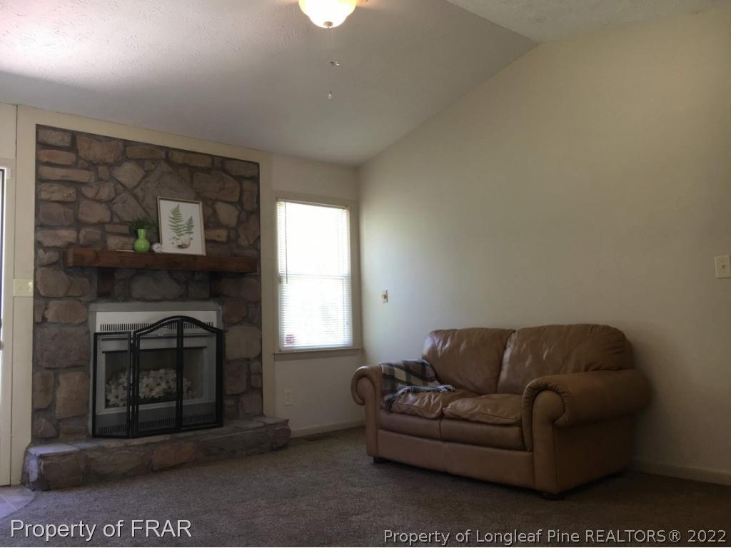 1733 Rim Road Fayetteville, NC 28314 - Photo 5 of 23 a living room with furniture a window and a fireplace