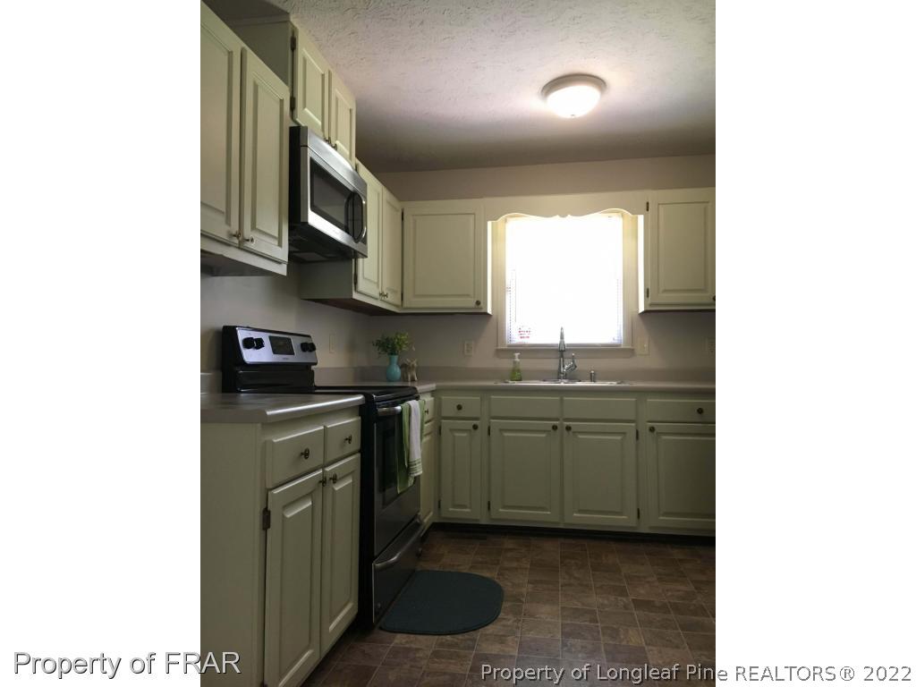 1733 Rim Road Fayetteville, NC 28314 - Photo 8 of 23 a kitchen with stainless steel appliances granite countertop a sink and a stove