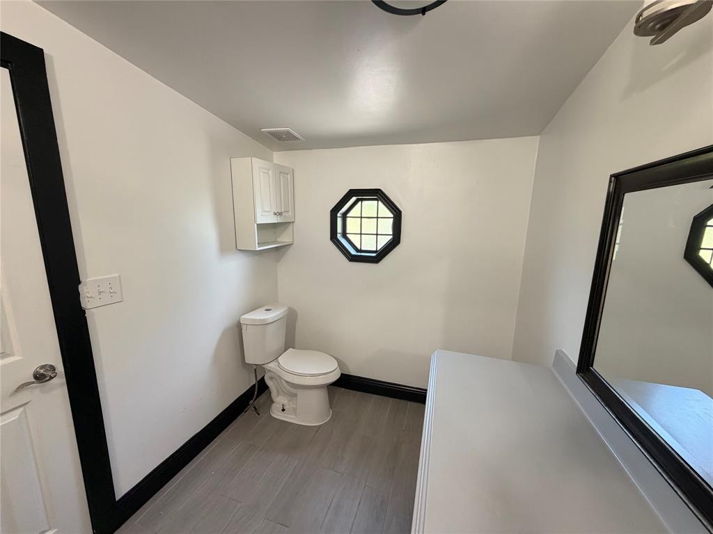 222 Hix Road Cleburne, TX 76031 - Photo 12 of 27 a bathroom with a toilet and a shower