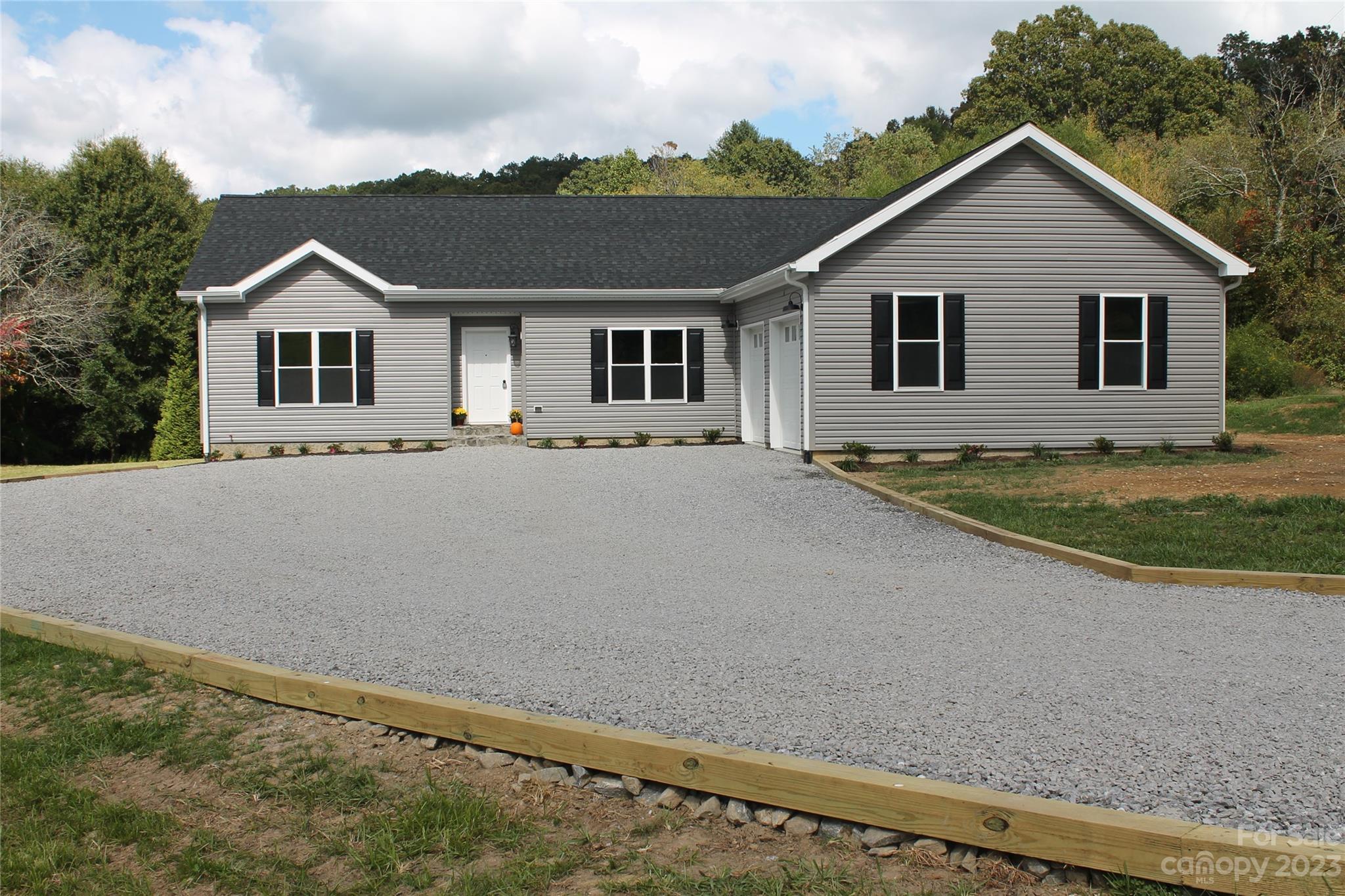 85 Rocky Lane Road Clyde, NC 28721 - Photo 2 of 37 a house with trees in the background