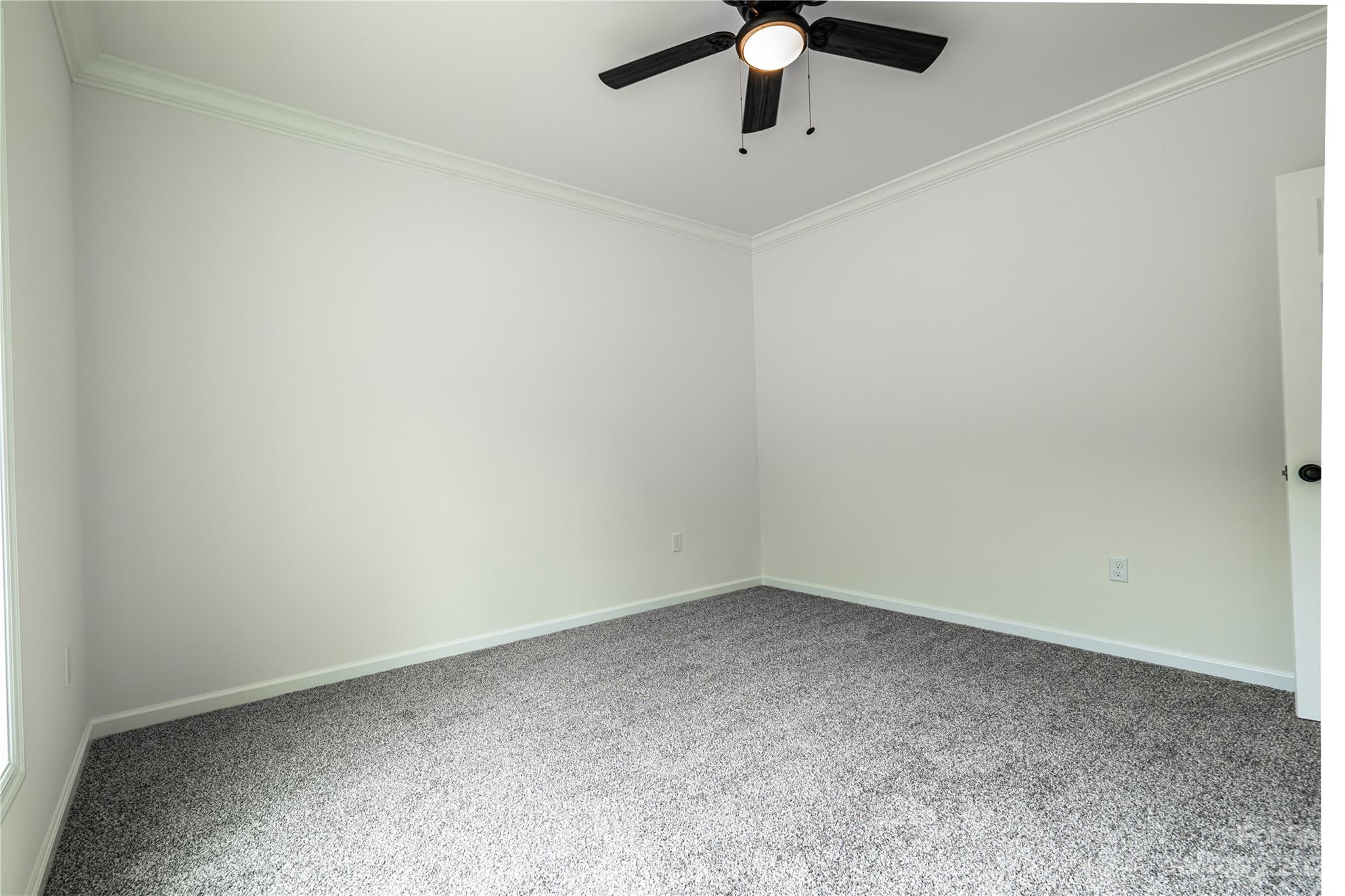 85 Rocky Lane Road Clyde, NC 28721 - Photo 23 of 37 an empty room with a ceiling fan and carpet