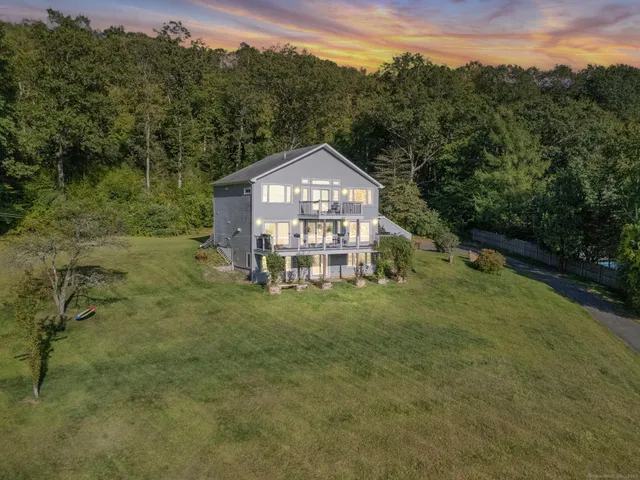 a view of a big yard with a house in the background