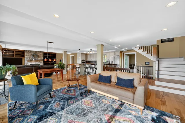 a living room with furniture kitchen view and a table
