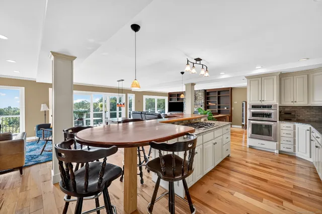 a large kitchen with a table and chairs