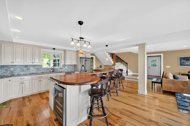 a kitchen with stainless steel appliances granite countertop a stove and a wooden floors