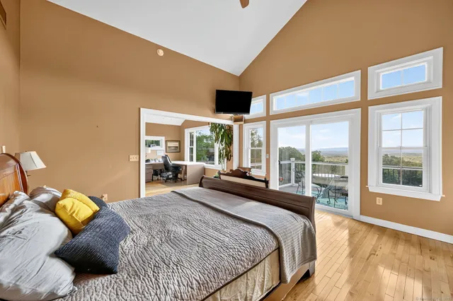 a bedroom with a large bed and a large window