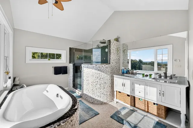 a large white kitchen with a large window