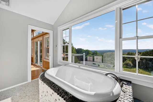 a living room with a large window and a table