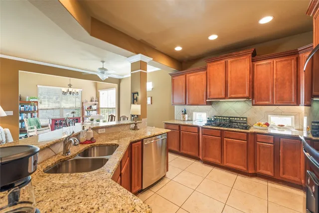 a kitchen with stainless steel appliances granite countertop sink stove and granite counter top