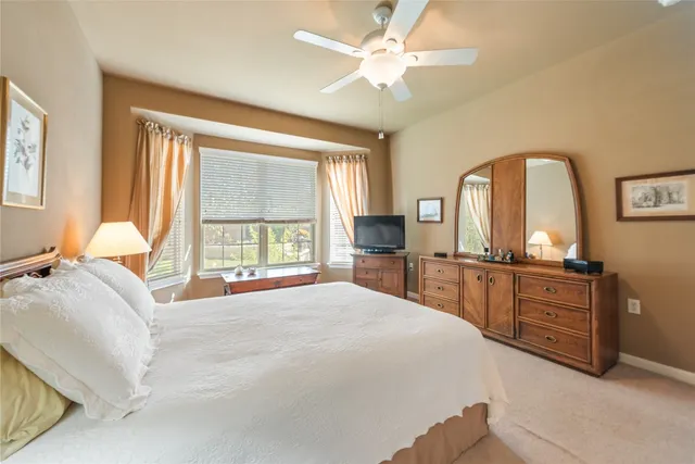 a bedroom with a large bed and a large window