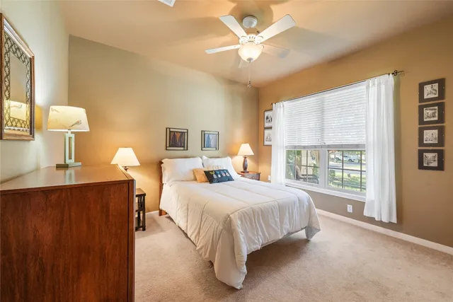 a bedroom with a large bed and a window