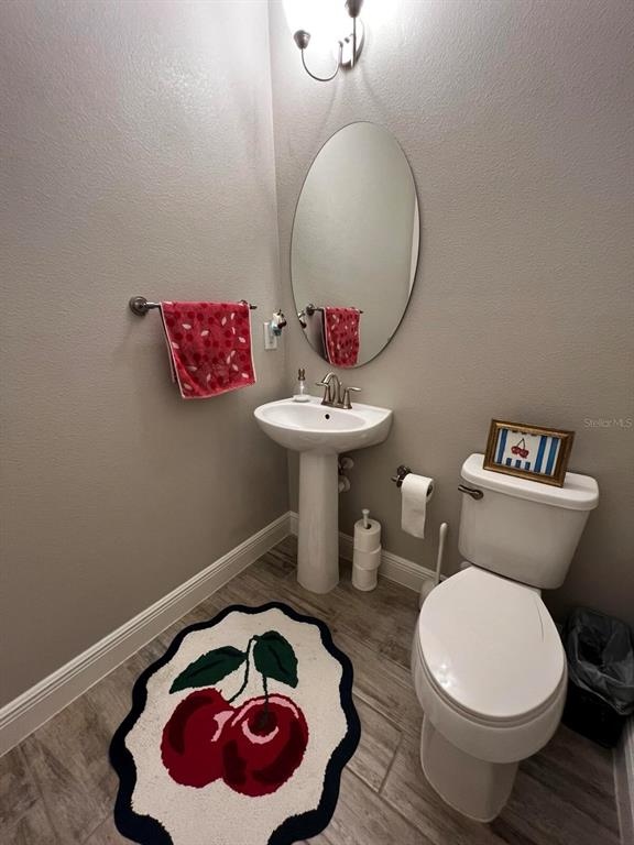 1505 Sunset Wind Loop Oldsmar, FL 34677 - Photo 8 of 25 a bathroom with a toilet sink and mirror