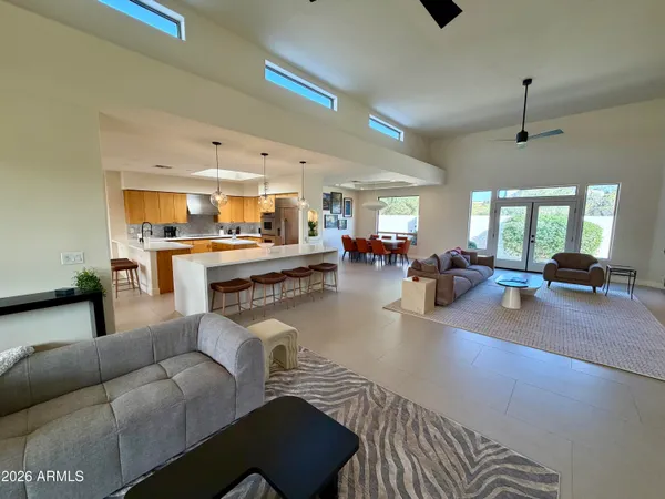 a living room with furniture and a chandelier