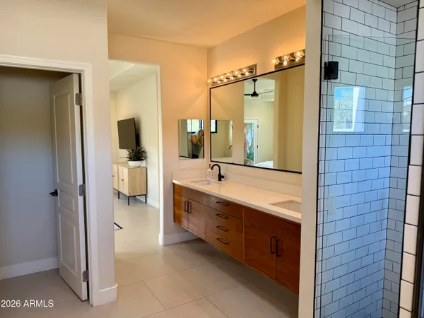 a bathroom with double vanity sinks and a mirror
