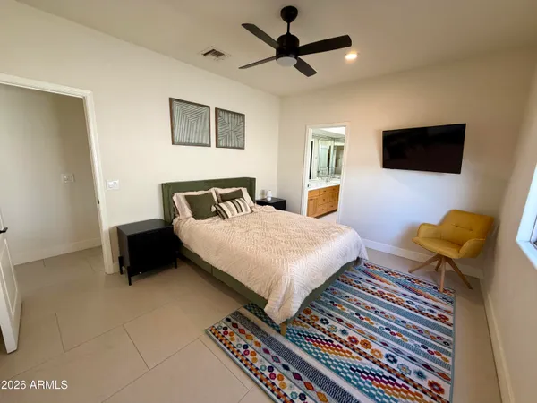 a bedroom with a bed and a flat screen tv
