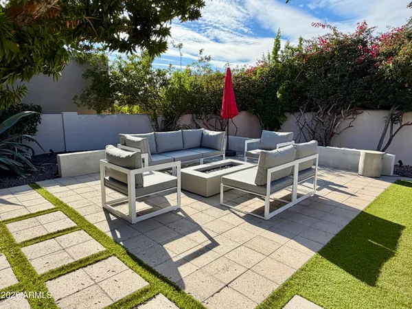 a view of a patio with table and chairs and potted plants