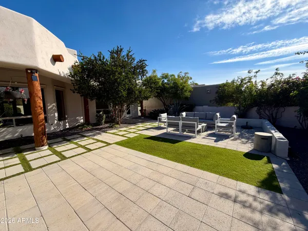 a swimming pool with outdoor seating and yard