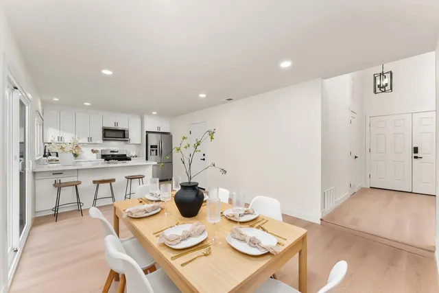 a view of a dining room with furniture and wooden floor