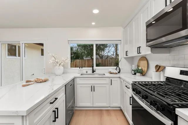 a kitchen with a sink stove and cabinets