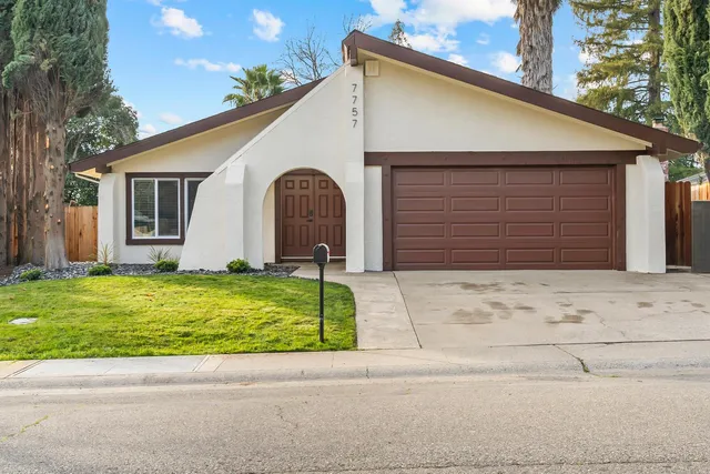 a small white house with a outdoor space