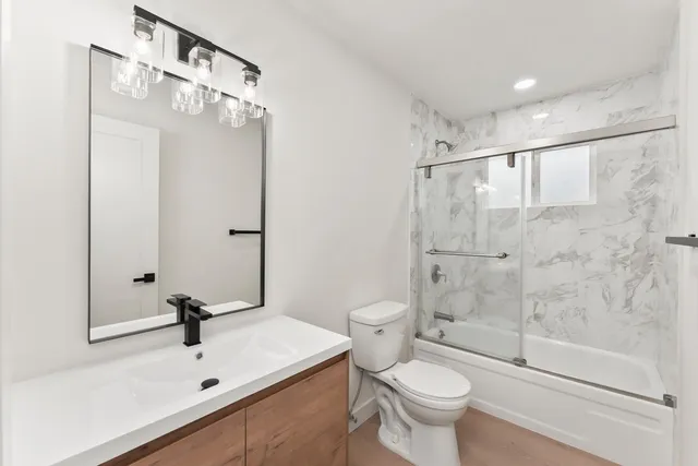 a bathroom with a sink toilet and shower